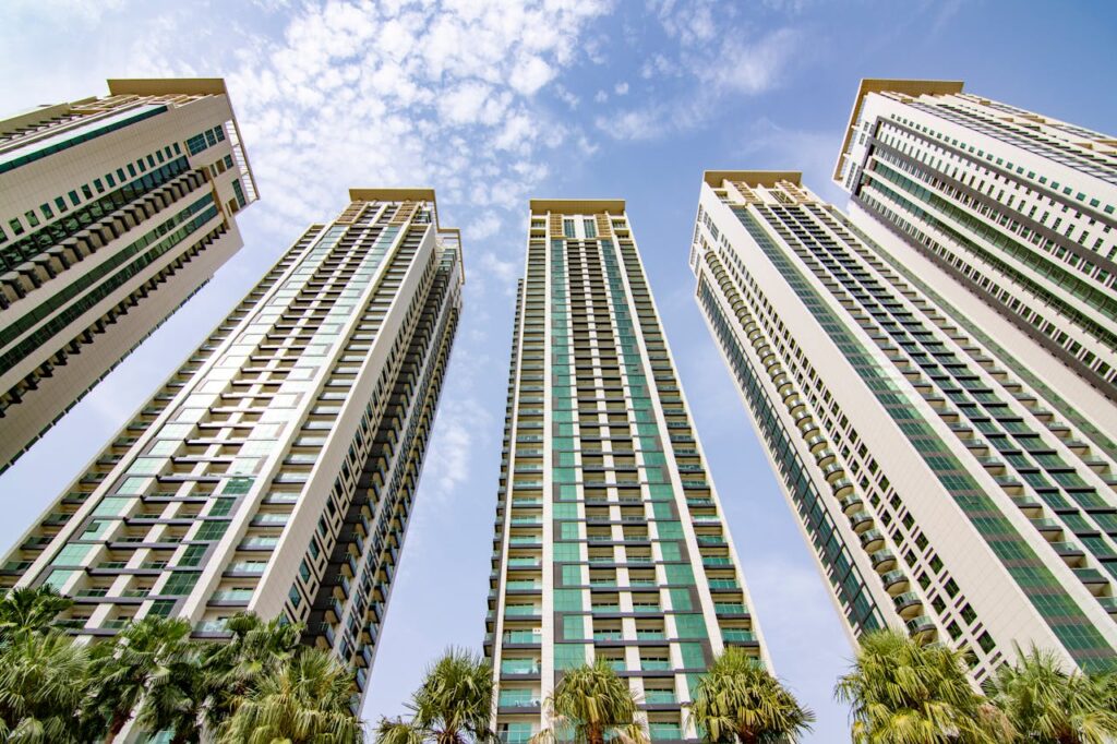 pexels-photo-9016774 Low-angle view of modern skyscrapers under a blue sky in Abu Dhabi, showcasing urban architecture.